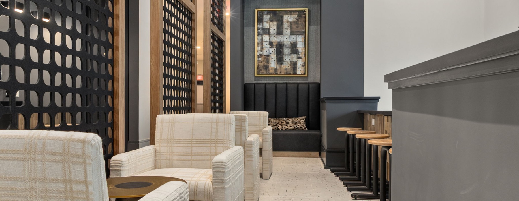 Resident lounge with chairs and tables at Emorie apartments in the Triangle.