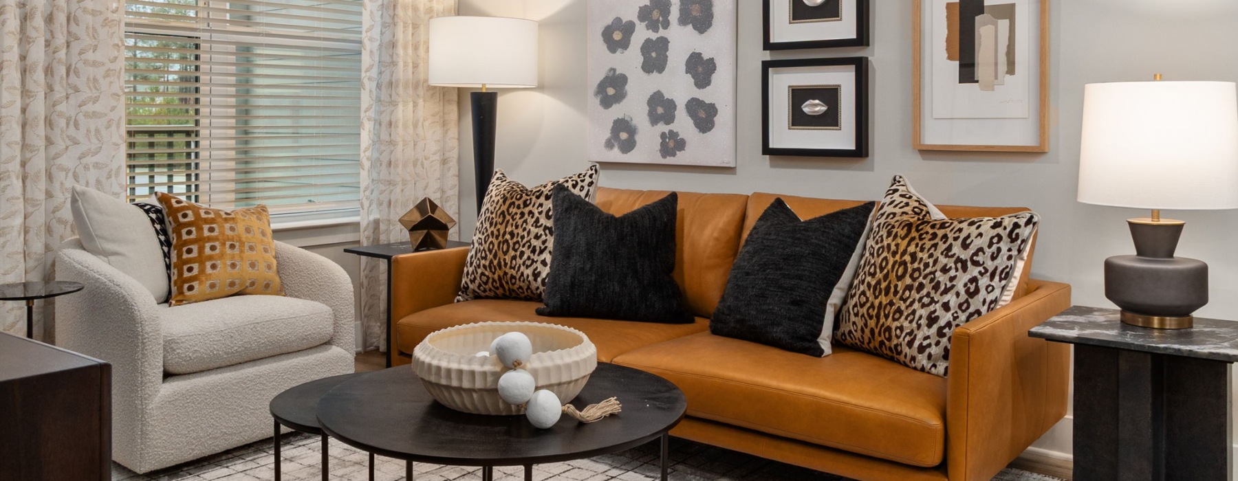 Living room with sofa and chair at Emorie Cary, NC apartments for rent.