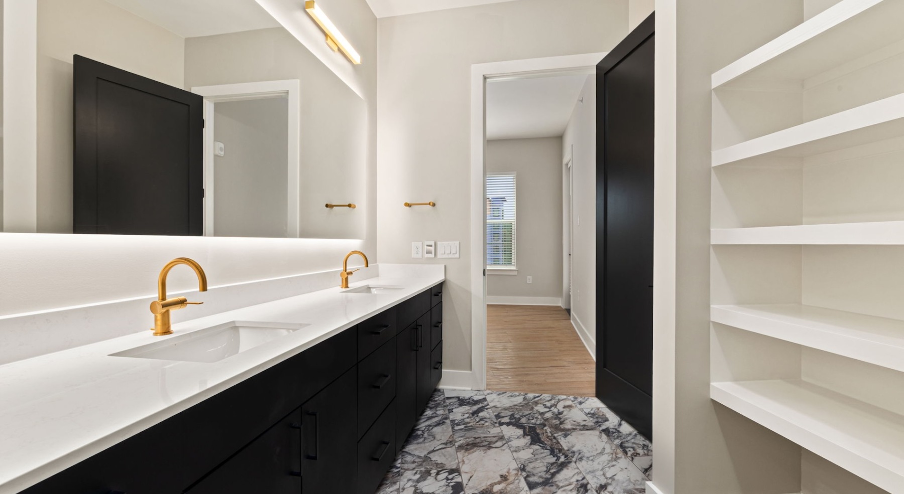 a spacious bathroom with a large mirror and ample light